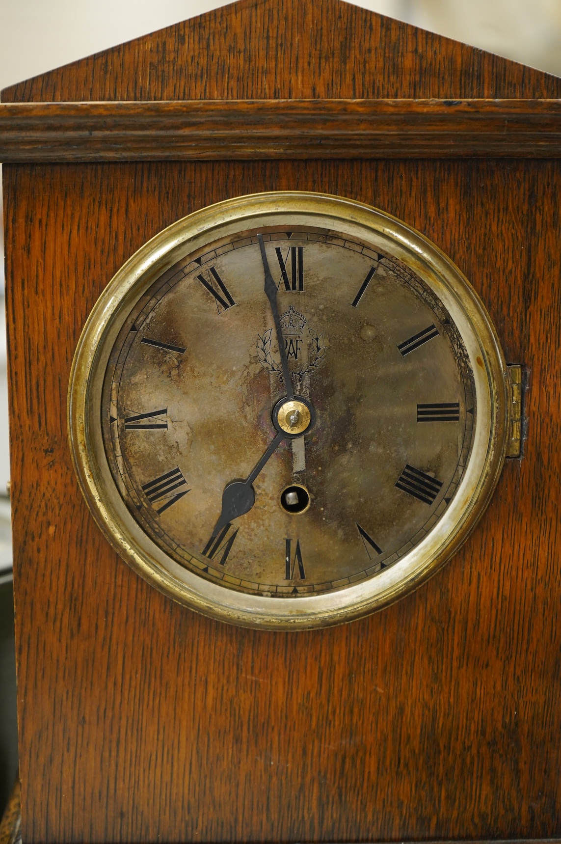 A RAF oak cased Officer's Mess mantel timepiece, with winding key, case key and pendulum, silvered dial engraved with crowned RAF surrounded by laurel insignia, and an 8 day fusee movement by F.W. Elliott, dated 1938, 35